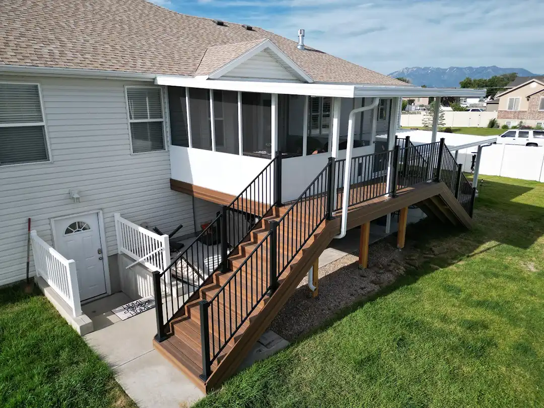 Photo of a composite deck with black metal railing.