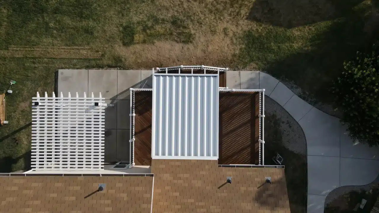 custom deck and concrete patio with a multi-level pergola design